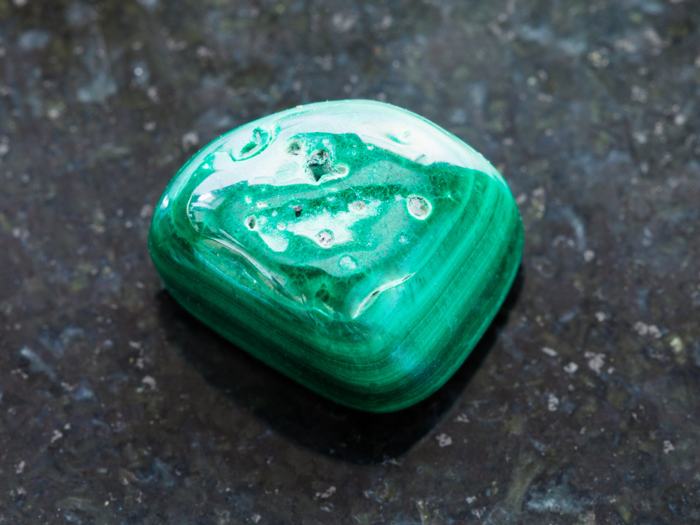 Polished Malachite Gemstone on Dark Surface