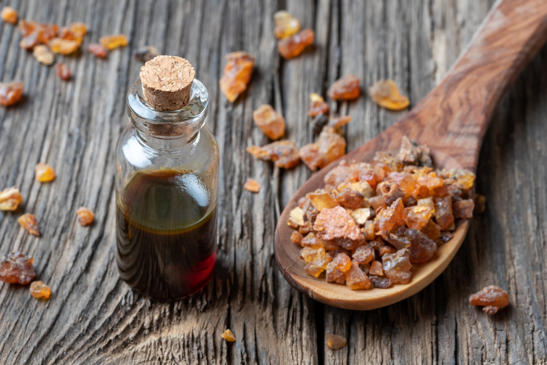 A bottle of myrrh essential oil with myrrh resin