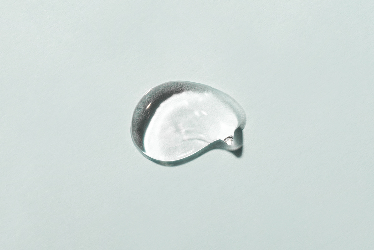 Transparent Hyaluronic Acid Gel on a Gray Background.